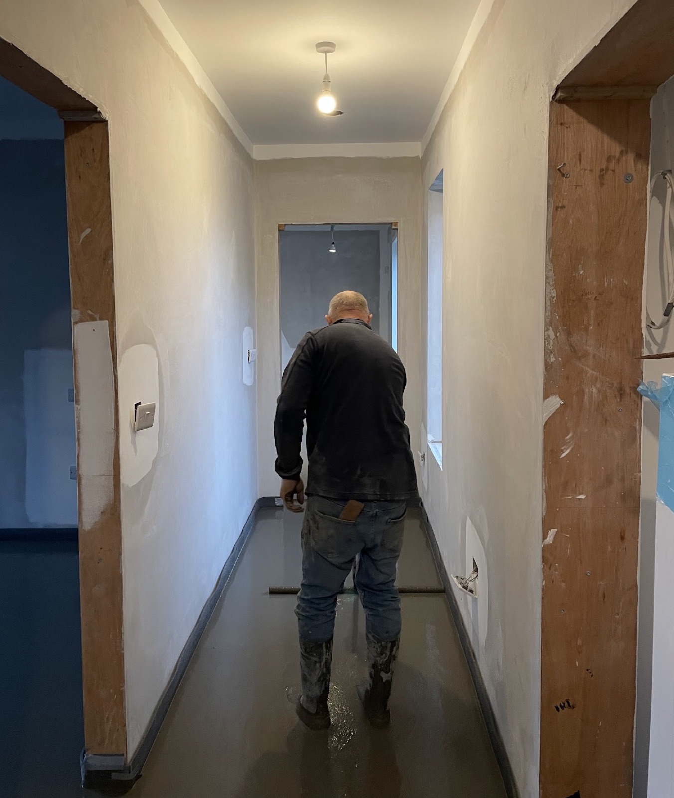 EvenScreed contractor finishing liquid screed in hallway