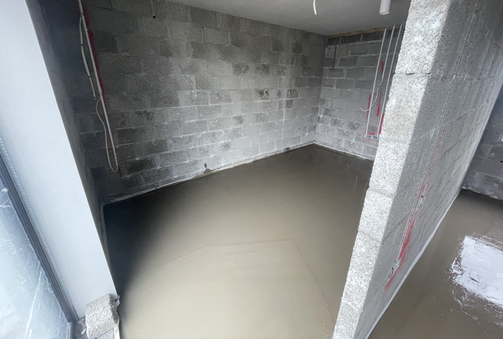 Liquid screed poured in blockwork utility room