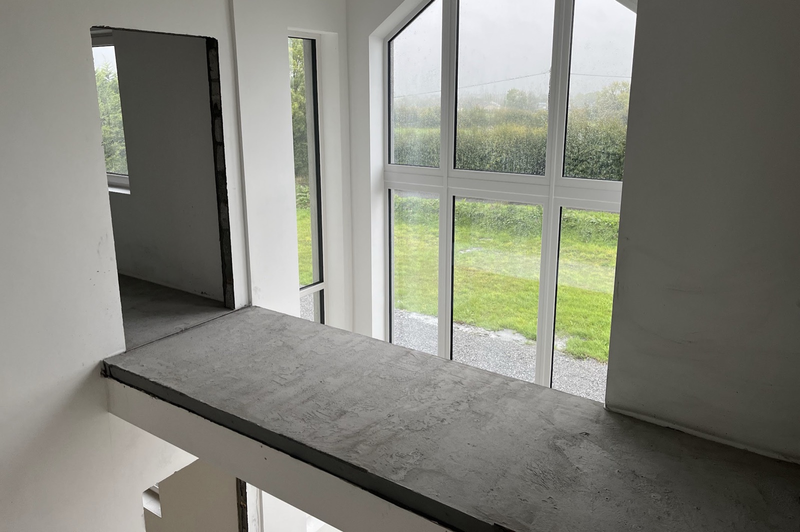 Liquid screed flooring beside apex window with countryside view