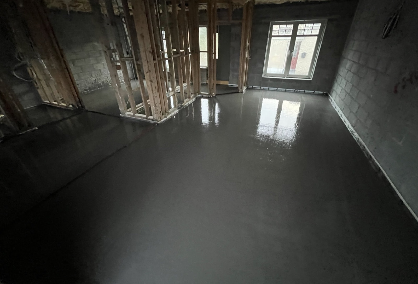Liquid screed poured in new-build room under construction